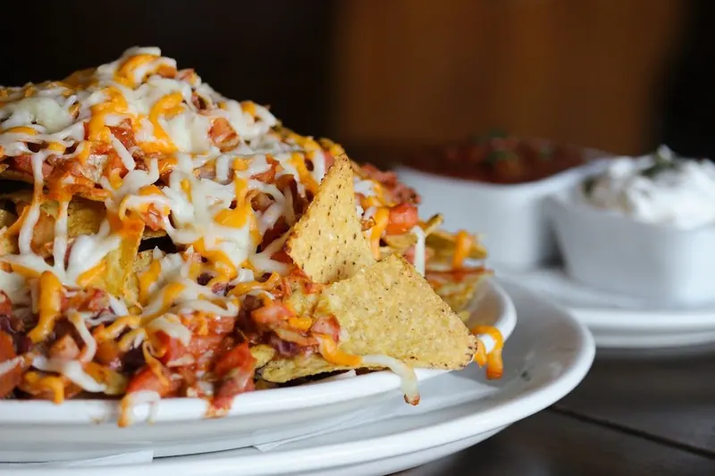 Nachos piled with cheese and toppings