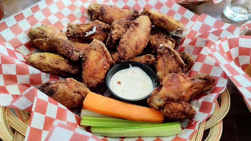 Basket of chicken wings with ranch, carrots and celery